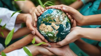 Hands wrapped around a brain-shaped mold of the Earth