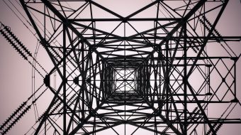 View looking straight up a high voltage tower.