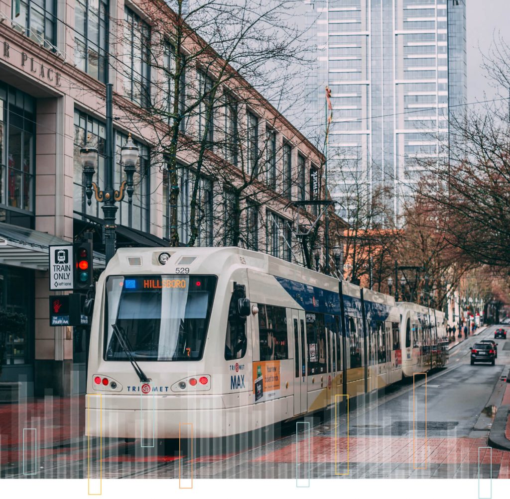 Portland transit train riding through the city on an overcast day.