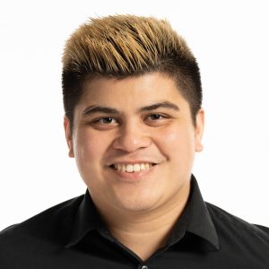 Latino male in a black shirt smiling.