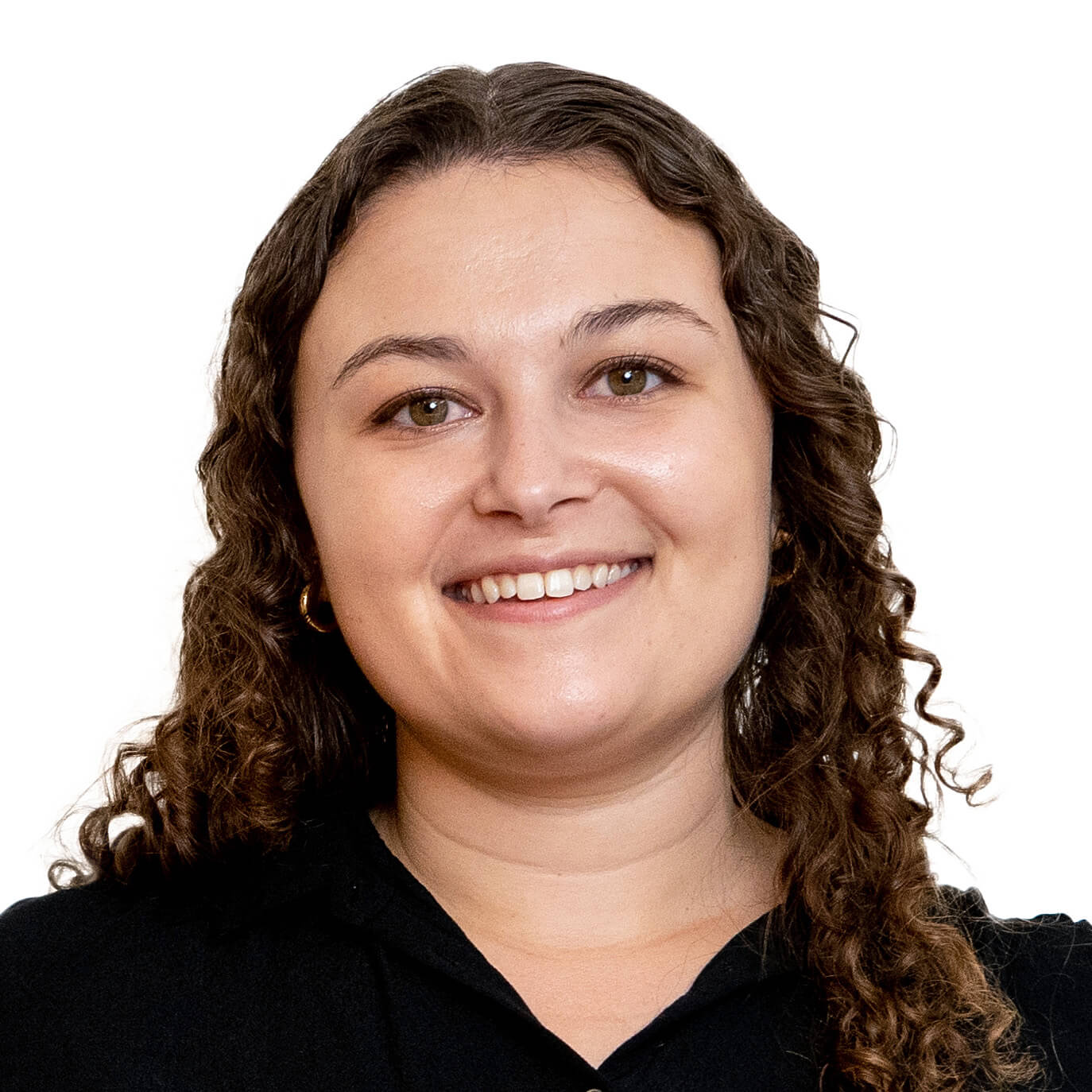 Curly-haired brunette woman in black top smiling.