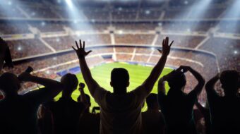 Fans cheering in a soccer stadium